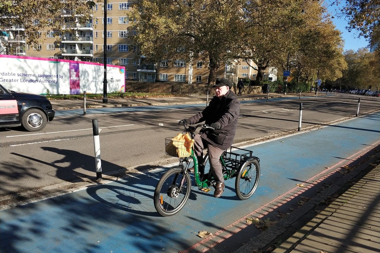 A cyclist on a protected bike lane in London, UK