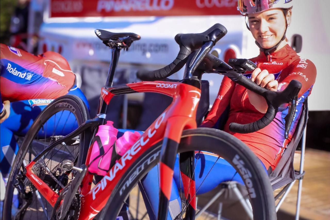 Sylvie Swinkels sits proudly beside one of the team's new Pinarello Dogma F road bikes